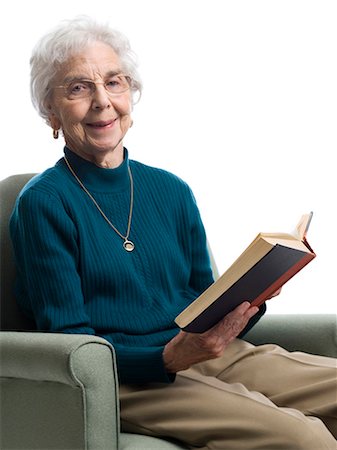 eye glasses for elderly - Elderly woman sitting in an armchair smiling Stock Photo - Premium Royalty-Free, Code: 640-03262563