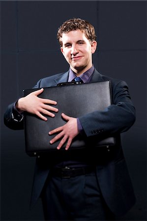 simsearch:640-03262574,k - Business man with briefcase and arm up smiling Foto de stock - Sin royalties Premium, Código: 640-03262574