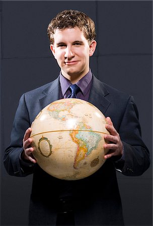 Businessman holding globe Stock Photo - Premium Royalty-Free, Code: 640-03262575