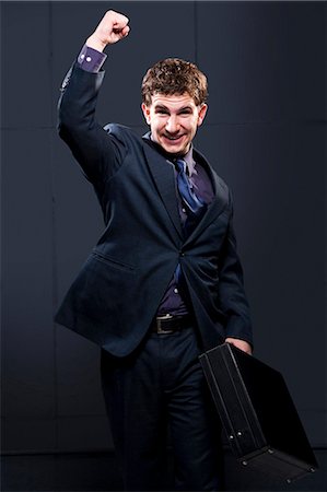 stretching one man - Business man with briefcase and arm up smiling Stock Photo - Premium Royalty-Free, Code: 640-03262572
