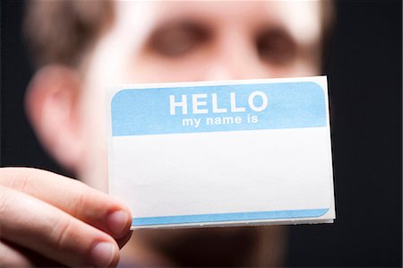 simsearch:640-03262582,k - Man holding blank name tag Stock Photo - Premium Royalty-Free, Code: 640-03262582