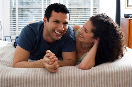 Man and woman on bed snuggling Stock Photo - Premium Royalty-Free, Code: 640-03262614