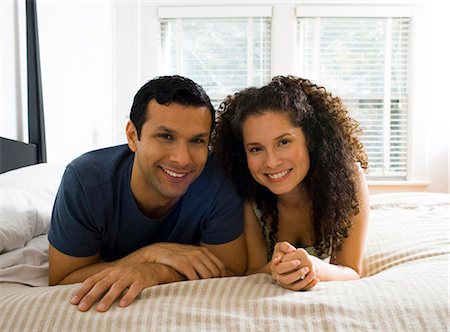 Man and woman on bed snuggling Stock Photo - Premium Royalty-Free, Code: 640-03262616