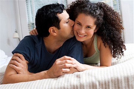 Man and woman on bed snuggling Stock Photo - Premium Royalty-Free, Code: 640-03262619