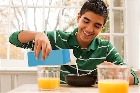 drink with boy image - Boy eating breakfast Stock Photo - Premium Royalty-Free, Code: 640-03262643
