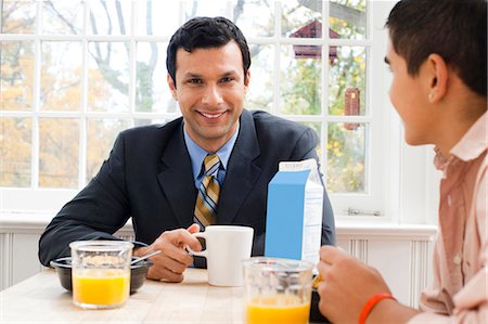 photos of a dad dining with his son - Man and boy at breakfast table displeased Stock Photo - Premium Royalty-Free, Code: 640-03262654