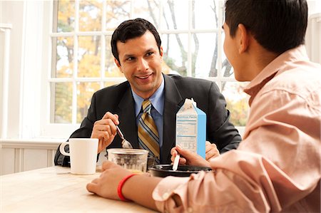 father teenager not girl not mother not woman - Man and boy au petit déjeuner table mécontent Photographie de stock - Premium Libres de Droits, Code: 640-03262656