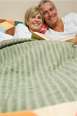 Mature couple in bed reading Stock Photo - Premium Royalty-Free, Code: 640-03262877