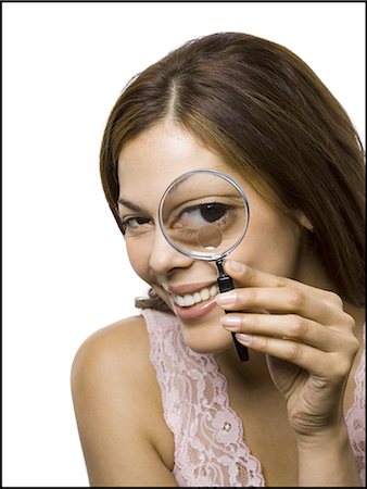 eye glass - Closeup of woman looking through magnifying glass Stock Photo - Premium Royalty-Free, Code: 640-03263029