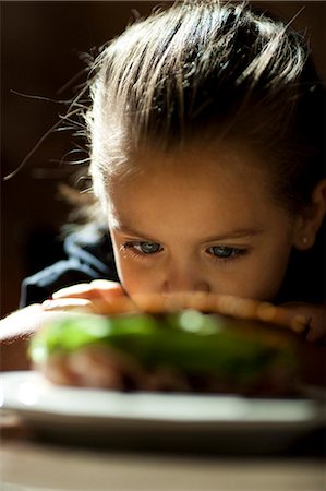 simsearch:640-03260960,k - Young girl looking at sandwich sulking Stock Photo - Premium Royalty-Free, Code: 640-03263097