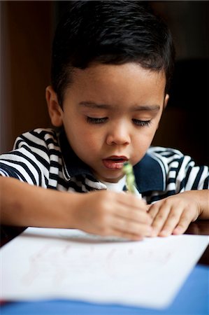Portrait of young boy coloring Stock Photo - Premium Royalty-Free, Code: 640-03263104