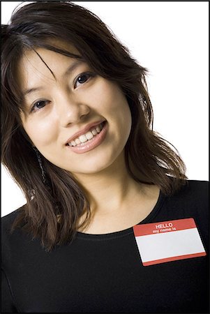 Portrait of a woman with blank name tag Stock Photo - Premium Royalty-Free, Code: 640-03263120