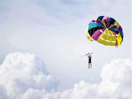 parachuting - Man with parachute floating Stock Photo - Premium Royalty-Free, Code: 640-03263200