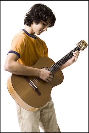 simsearch:640-03263387,k - Boy playing the guitar Fotografie stock - Premium Royalty-Free, Codice: 640-03263394