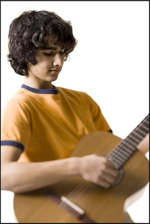 Boy playing the guitar Stock Photo - Premium Royalty-Free, Code: 640-03263396