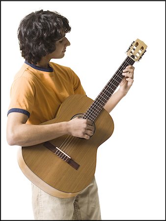 Boy playing the guitar Foto de stock - Sin royalties Premium, Código: 640-03263390