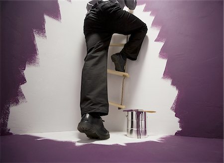 Man climbing a ladder Stock Photo - Premium Royalty-Free, Code: 640-03263624