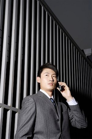 simsearch:640-02950930,k - Young businessman using mobile phone Stock Photo - Premium Royalty-Free, Code: 642-01734017