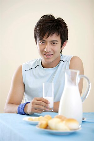 Portrait of a young man holding a glass of milk Stock Photo - Premium Royalty-Free, Code: 642-01734261