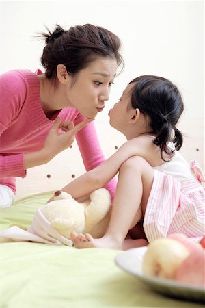 simsearch:642-01734328,k - Mother and daughter sitting face to face and kissing Stock Photo - Premium Royalty-Free, Code: 642-01734316