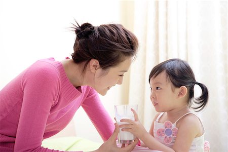 simsearch:642-01734328,k - Girl feeding mother with a glass of milk, side view Stock Photo - Premium Royalty-Free, Code: 642-01734321