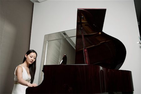 piano performance dress - Young woman playing grand piano Stock Photo - Premium Royalty-Free, Code: 642-01734439