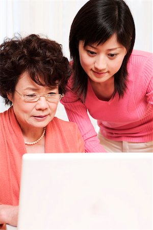 daughter helping elderly parent - Mother and daughter playing with laptop Stock Photo - Premium Royalty-Free, Code: 642-01734673
