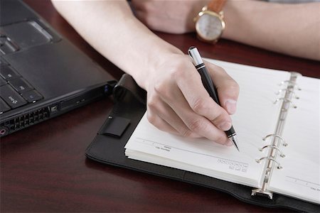 Businessman writing in a diary, close-up Stock Photo - Premium Royalty-Free, Code: 642-01734708