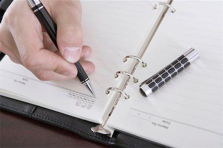 Businessman writing in a diary, close-up Stock Photo - Premium Royalty-Free, Code: 642-01734709