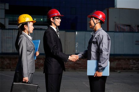 Businessmen shaking hands by businesswomen Stock Photo - Premium Royalty-Free, Code: 642-01734782