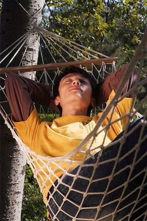 pictures of men sleeping in hammocks - Young man sleeping on hammock Stock Photo - Premium Royalty-Free, Code: 642-01734969