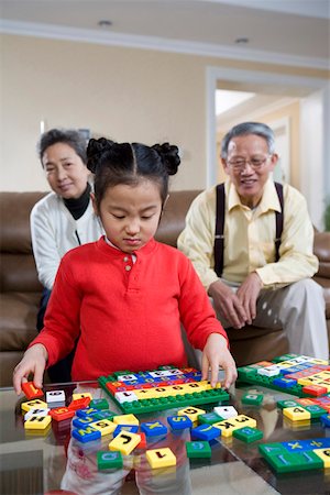 playing alphabets pictures - Senior couple playing spelling game with granddaughter Stock Photo - Premium Royalty-Free, Code: 642-01735014