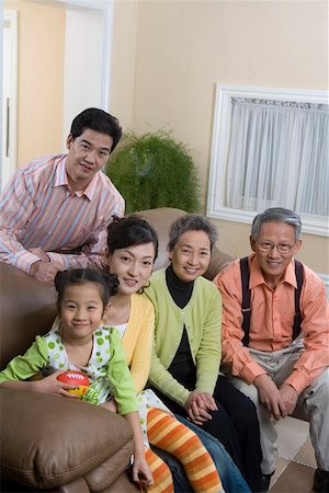 Portrait of family sitting together and smiling Stock Photo - Premium Royalty-Free, Code: 642-01735024