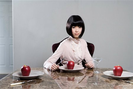 plate red wine glass - Portrait of a young woman sitting at dinning table with apples Stock Photo - Premium Royalty-Free, Code: 642-01735044