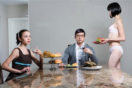 Woman serving men and women at breakfast table Stock Photo - Premium Royalty-Free, Code: 642-01735074