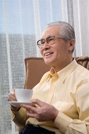 Senior man holding cup of tea, smiling Stock Photo - Premium Royalty-Free, Code: 642-01735115