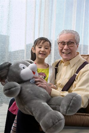 simsearch:642-01735677,k - Granddaughter and grandfather holding teddy bear, smiling, portrait Stock Photo - Premium Royalty-Free, Code: 642-01735118