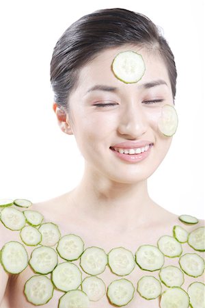 Young woman and cucumber slices Stock Photo - Premium Royalty-Free, Code: 642-01735201