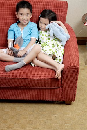 simsearch:642-01736683,k - Boy and girl holding dolls in sofa Stock Photo - Premium Royalty-Free, Code: 642-01735540