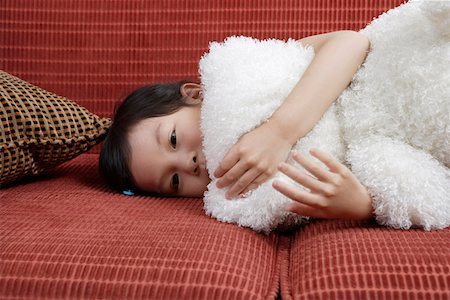 simsearch:642-01736683,k - Girl lying in sofa with doll Stock Photo - Premium Royalty-Free, Code: 642-01735596