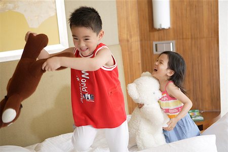 simsearch:642-01734328,k - Children playing with toys on bed Stock Photo - Premium Royalty-Free, Code: 642-01735617