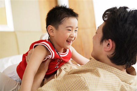 Father playing with son, smiling Stock Photo - Premium Royalty-Free, Code: 642-01735626