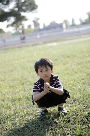 simsearch:642-01732852,k - Portrait of a boy crouching Stock Photo - Premium Royalty-Free, Code: 642-01735640