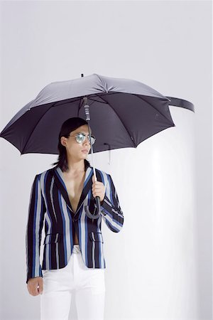 Young man with sunglasses and umbrella Stock Photo - Premium Royalty-Free, Code: 642-01735812