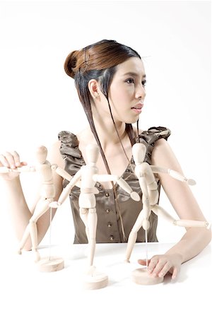 Portrait of a young woman with puppets Stock Photo - Premium Royalty-Free, Code: 642-01735822