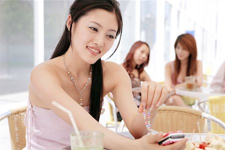 simsearch:642-01734897,k - Young woman with mobile phone, smiling Stock Photo - Premium Royalty-Free, Code: 642-01735901
