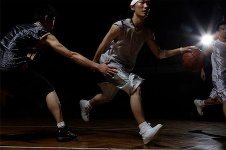 Three men playing basketball Stock Photo - Premium Royalty-Free, Code: 642-01735960