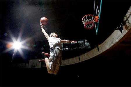 slam dunk - Young man jumping and dunking Stock Photo - Premium Royalty-Free, Code: 642-01735979