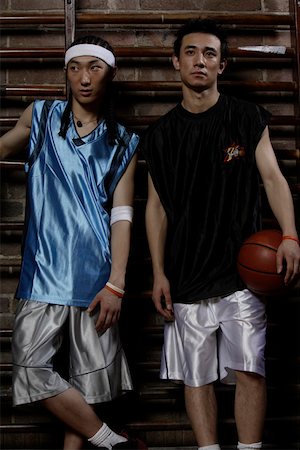 friends basketball - Man holding basketball while friend standing beside him Stock Photo - Premium Royalty-Free, Code: 642-01736037