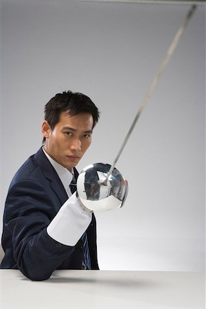sword - Young businessman with sword Stock Photo - Premium Royalty-Free, Code: 642-01736429